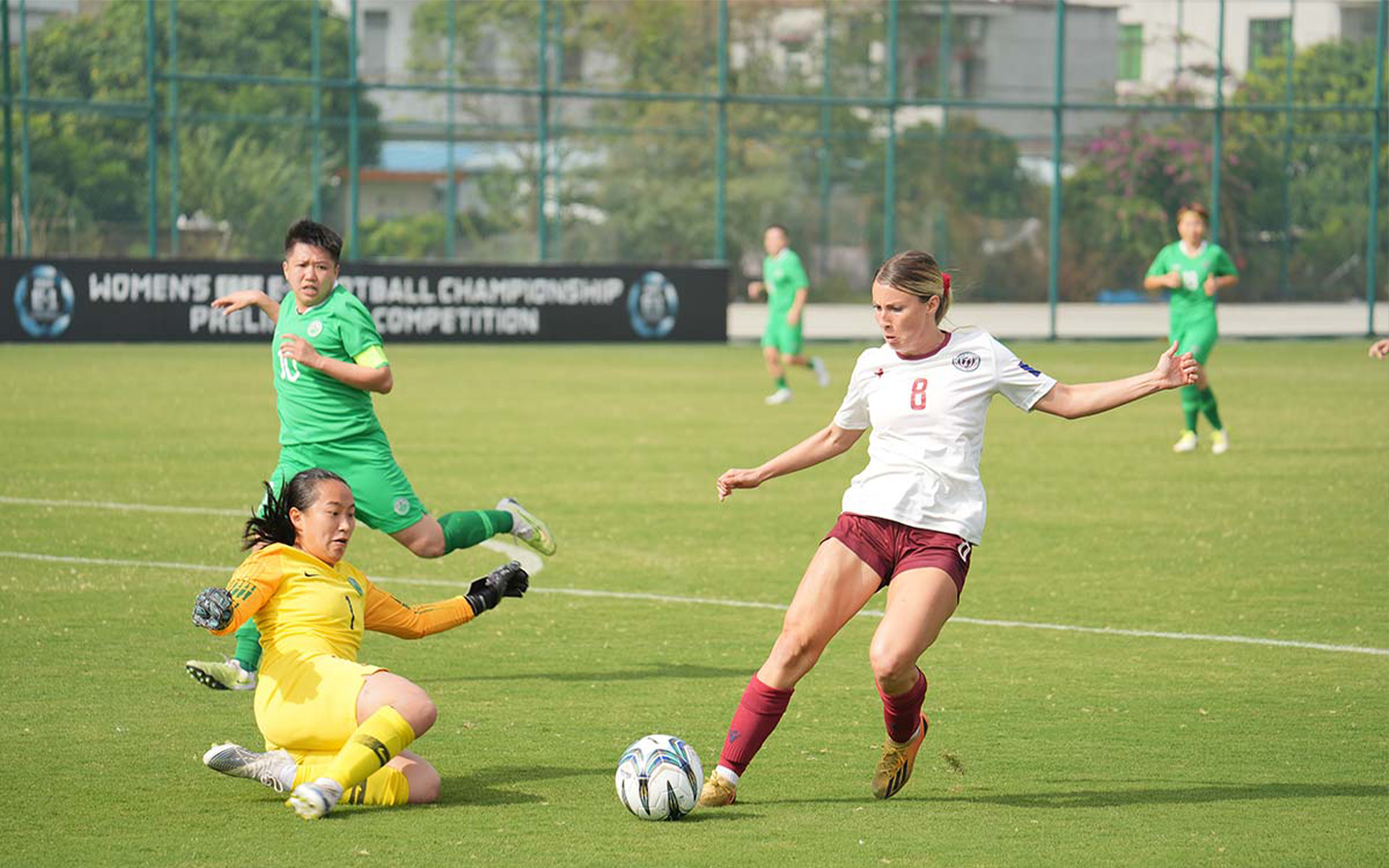 Macao women's football team's Oriana Wong battling it out with Guam's Rebecca Bartosh in the second preliminary match of the East Asian Football Federation’s Women’s Football Championship