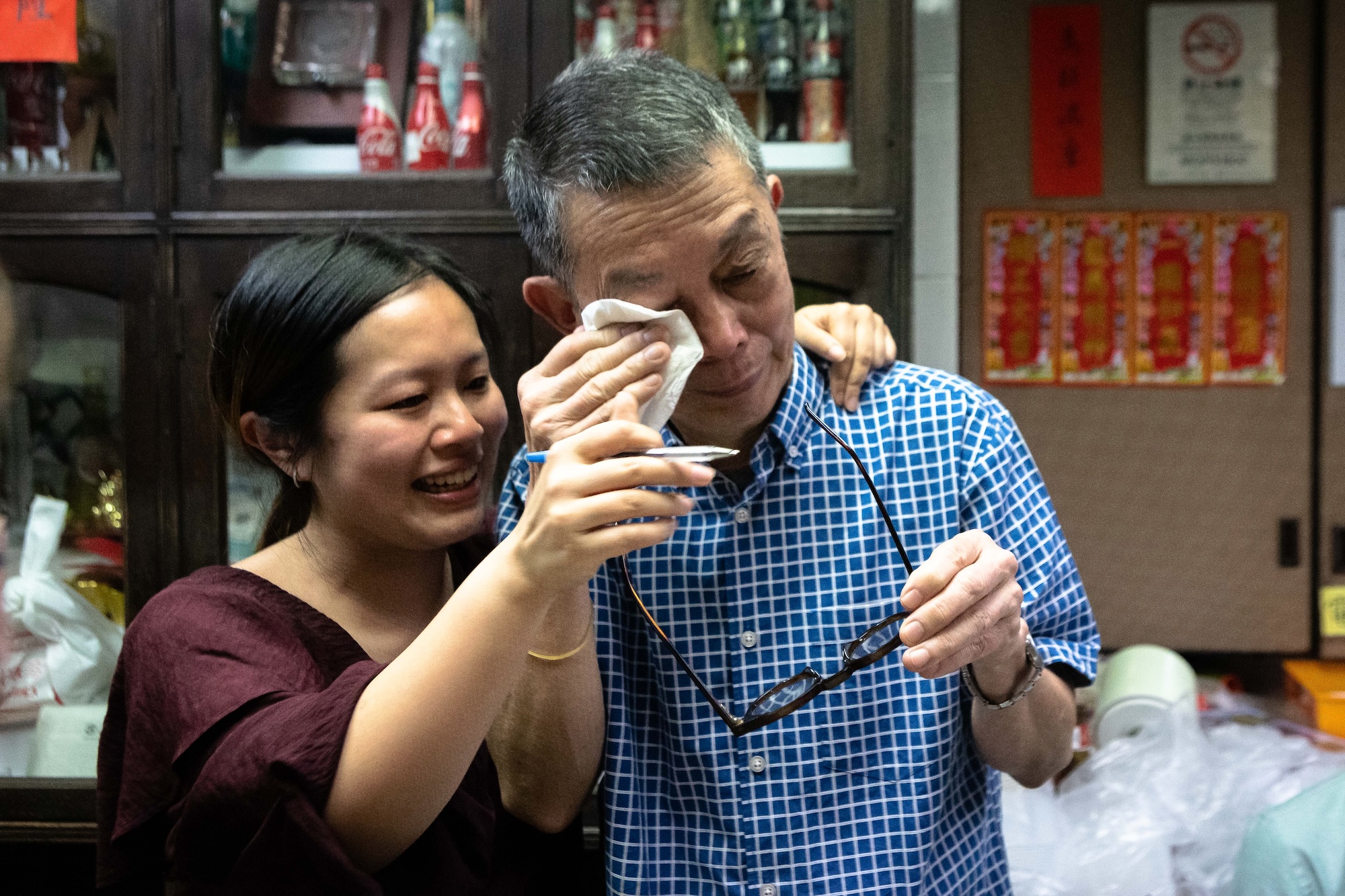 Overcome by the emotion of the moment, Lam Kok Veng dabs a tear from his eye