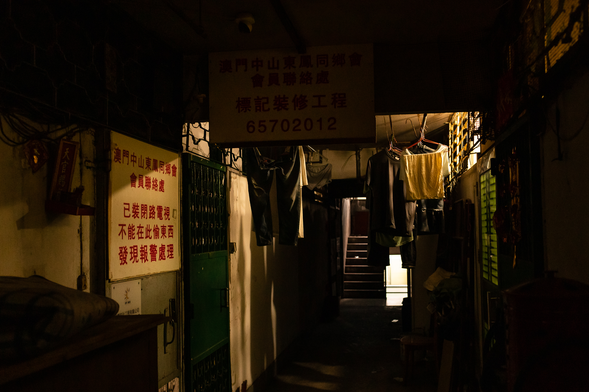 Sunlight filters through the windows of a corridor at the Iao Hon tenement building