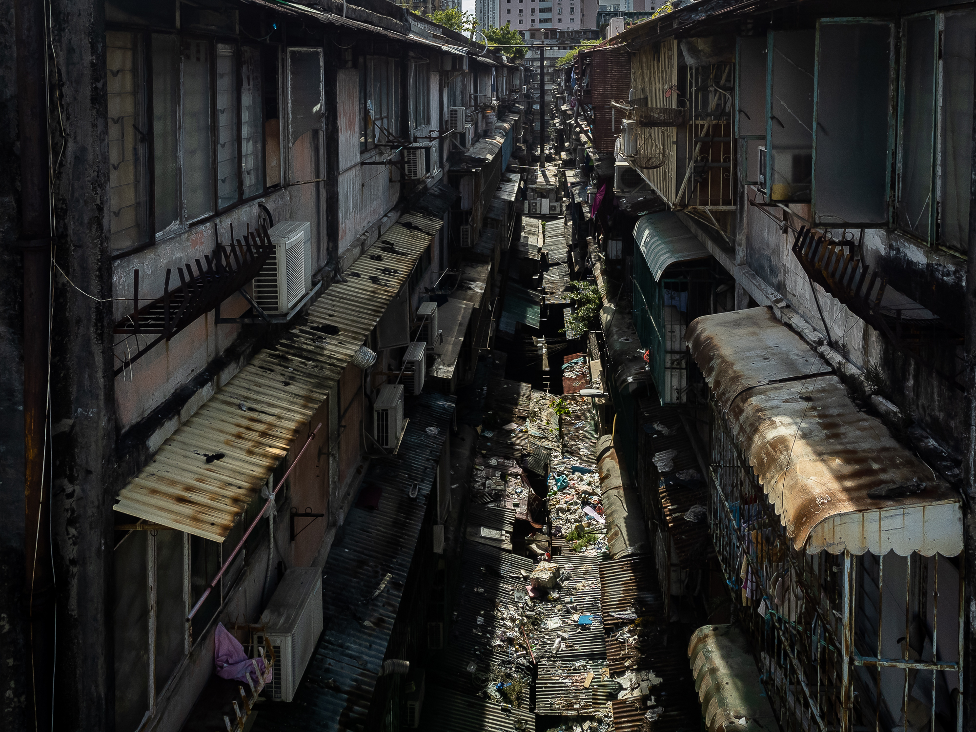 Rubbish piles up on the awnings of an alley at the Iao Hon apartment block